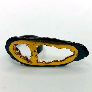 Black and gold colored ring